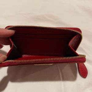 Burberry leather zip around card case. Color: Red